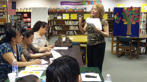 Instructor working with hispanic parents