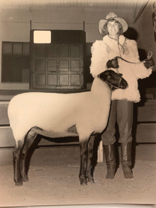 Black and white photo of Diane Kennedy with a goat.