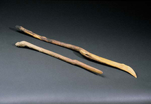 two wooden sticks with slanted ends.