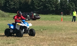 A youth member riding an ATV.