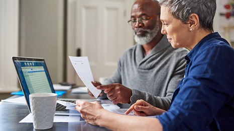 Older adults browsing financial documents