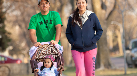 A Hispanic family with a child in a stroller