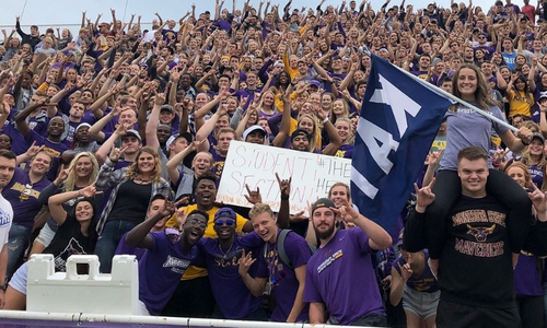 Attendees excited and sporting school colors at a Minnesota State University Mankato (MNSU) homecoming celebration.