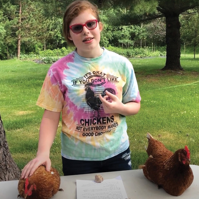4-H'er giving a talk about chickens outside