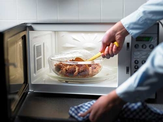 Stirring food in microwave.