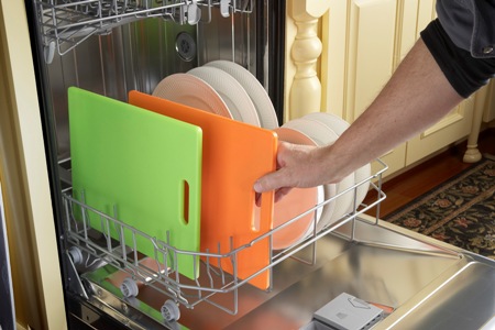 Placing colored cutting boards into the dishwasher