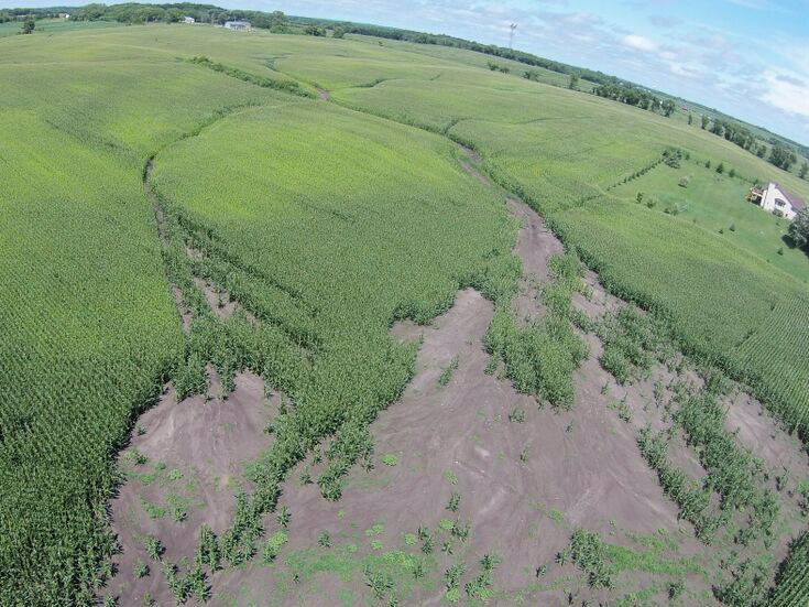 aerial view of a large crop area with a section washed away due to tillage and water erosion.