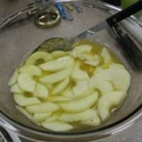 Peeled and sliced apples in a bowl.