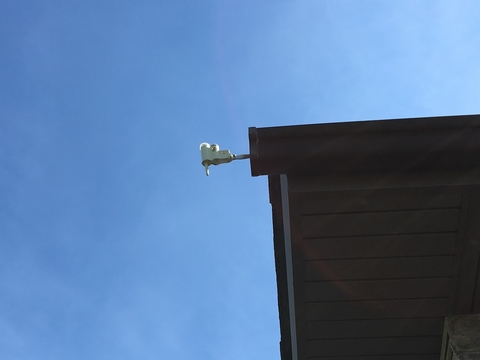 Rain gauge attached to a home’s roof.