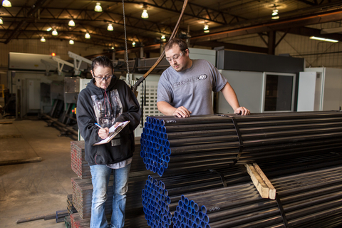 Twp employees working at a manufacturing pipe facility