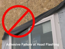 Adhesive failure at head flashing.